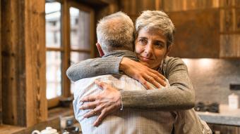 An older couple hugging